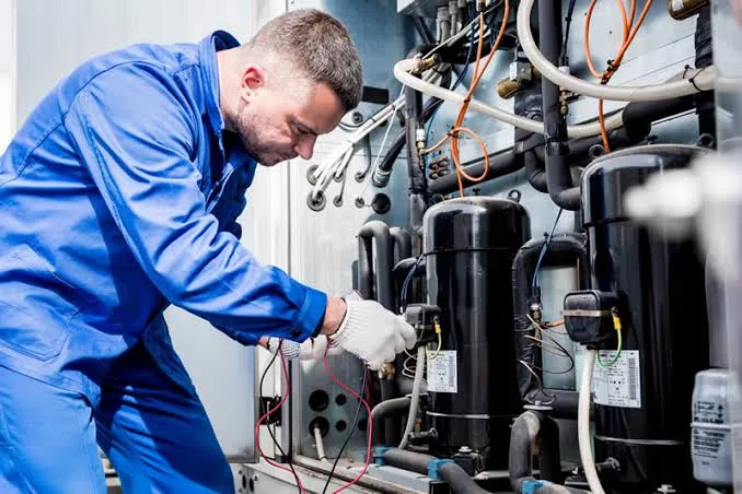 HVAC technician testing heating and cooling equipment