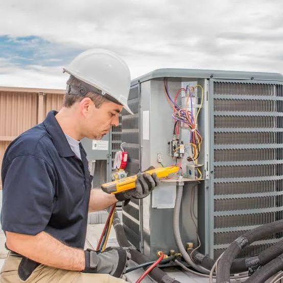 Technician using a meter to diagnose an HVAC system