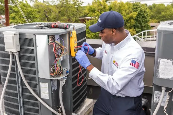 HVAC technician servicing rooftop comfort equipment